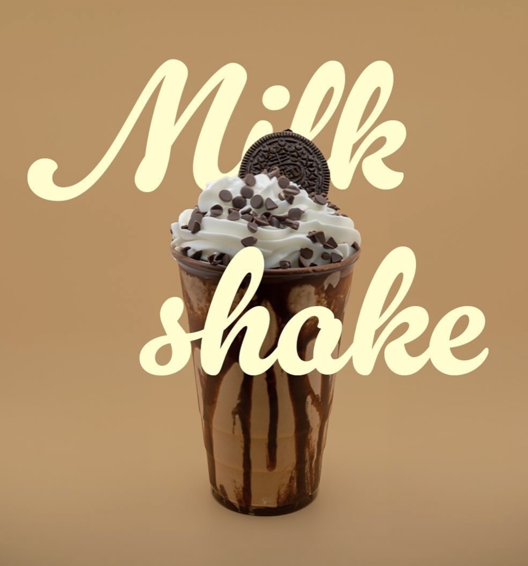 Chocolate milkshake topped with whipped cream, chocolate chips and an Oreo
